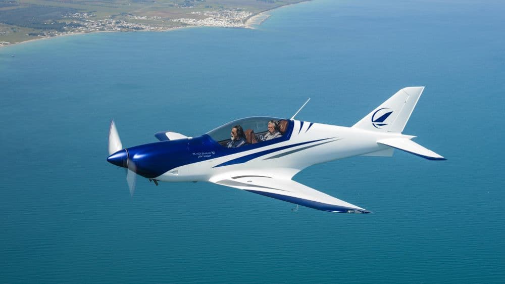 Sport aircraft flying over the sea